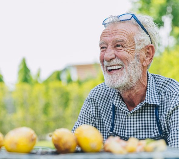 Man laughs at picnic table