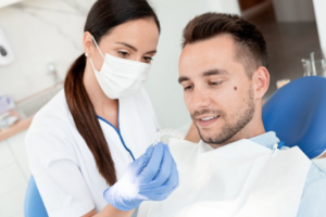 Dentist showing patient his new clear retainer